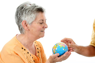 Image showing mature woman holding earth globe, protection concept