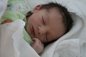 Image showing sweet baby sleeping on a blanket, newborn baby