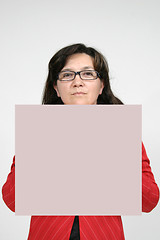 Image showing Young woman holding blank board