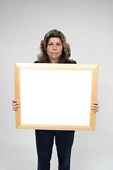 Image showing Young woman holding blank board