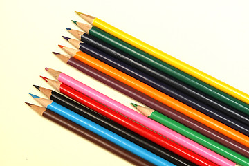 Image showing Assortment of coloured pencils with shadow on white background