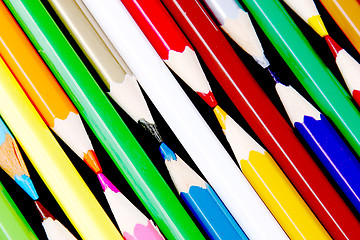 Image showing Assortment of coloured pencils with shadow on white/back backgro