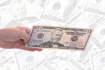 Image showing hand holding a dollar bill, business studio photo