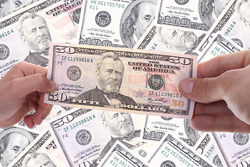 Image showing hand holding a dollar bill, business studio photo