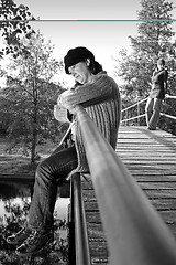 Image showing  beautiful woman in an autumn park 