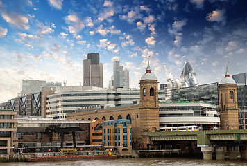 Image showing City of London with clouds, financial center and Canary Wharf at