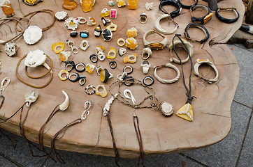 Image showing handmade jewellery  bone amber on wooden table 