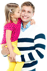 Image showing Sweet daughter kissing her smiling father
