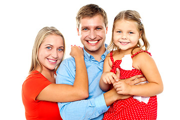 Image showing Cheerful family of three facing camera and smiling