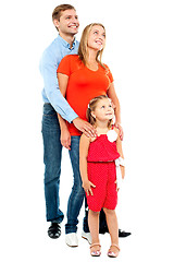 Image showing Couple with their girl child looking upwards