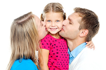 Image showing Mom and dad kissing their beautiful kid