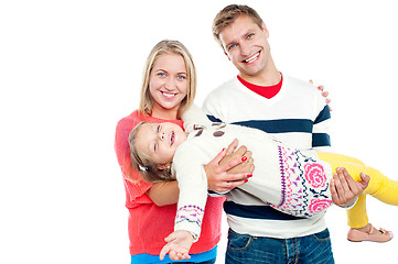 Image showing Excited daughter having fun in safe hands of her parents