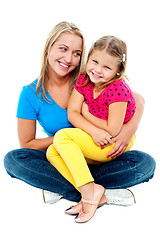 Image showing Cute daughter sitting in mother's lap