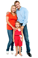 Image showing Mother, father and cute daughter posing in trendy outfits