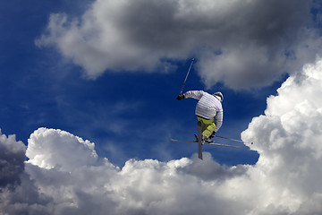 Image showing Freestyle ski jumper with crossed skis