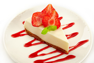 Image showing cheesecake with strawberries on white plate