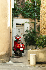 Image showing Small scooter parked at the old quarter buildings