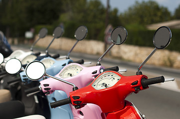 Image showing A line of mopeds/scooters