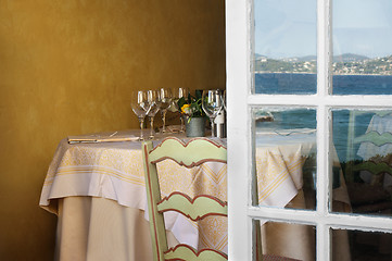 Image showing Arranged table in a restaurant and open window