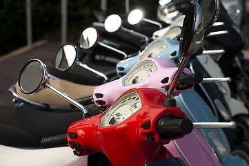 Image showing A line of mopeds/scooters