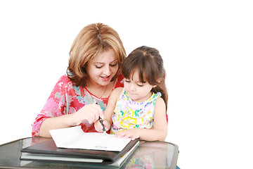 Image showing Mother and daughter doing homework at home 