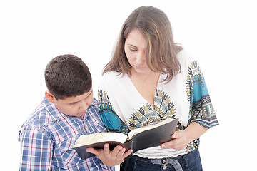 Image showing Mother and son reading a Bible over a black background 