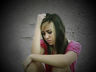 Image showing portrait of a sad teenage girl looking thoughtful about troubles