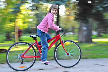 Image showing child riding  bike in park