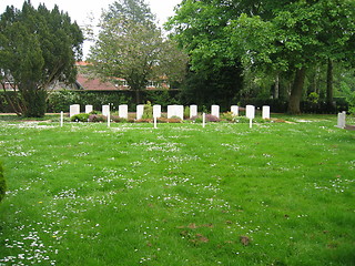 Image showing white gravestones in distance
