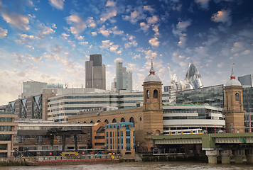 Image showing City of London with clouds, financial center and Canary Wharf at