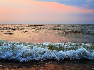 Image showing sunset at stormy sea