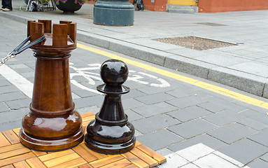 Image showing outdoor chess game figures near bicycle path 