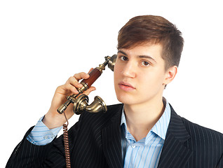 Image showing young man talking on retro phone