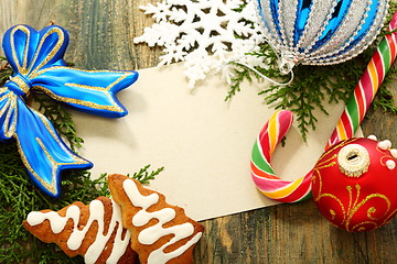 Image showing Christmas card with balls, candy and snowflakes.