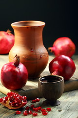 Image showing Ripe pomegranate and juice in cup.