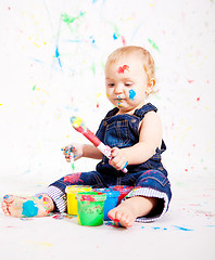 Image showing cute little baby painting and splatter with colours