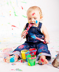 Image showing cute little baby painting and splatter with colours
