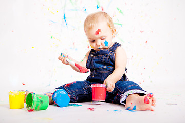 Image showing cute little baby painting and splatter with colours