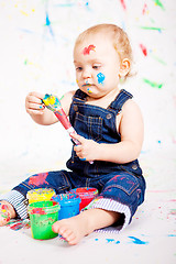 Image showing cute little baby painting and splatter with colours