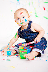 Image showing cute little baby painting and splatter with colours