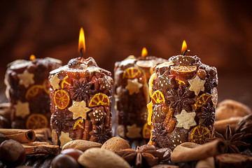 Image showing Rustic Christmas candles with spices and  nuts