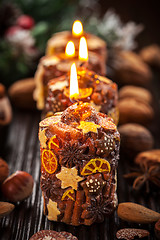 Image showing Rustic Christmas candles with spices and  nuts