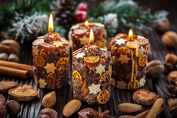 Image showing Rustic Christmas candles with spices and  nuts