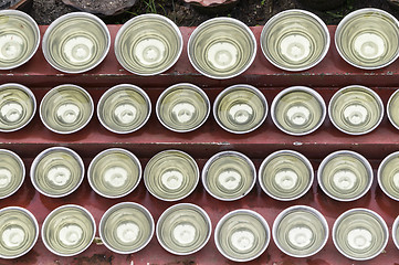 Image showing small bowls with water around a temple