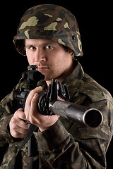 Image showing Watchful soldier aiming  m16 in studio