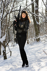 Image showing woman with a rifle in winter forest