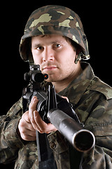 Image showing Soldier holding a gun in studio