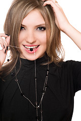 Image showing Portrait of smiling girl with a bead in her mouth