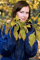 Image showing smiling girl amongst the autumn leaves
