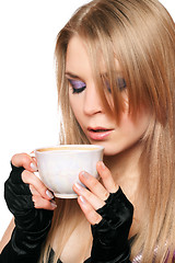 Image showing Attractive young blonde with a cup of tea. Isolated